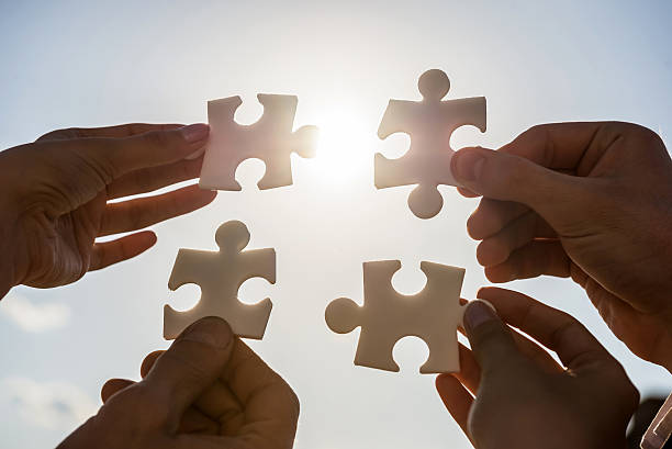 istock Businesspeople holding puzzle 473285742