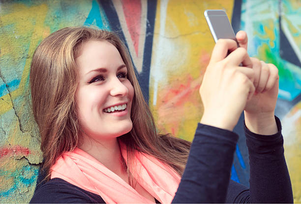 istock Young and beautiful girl posing against graffiti wall 473288438