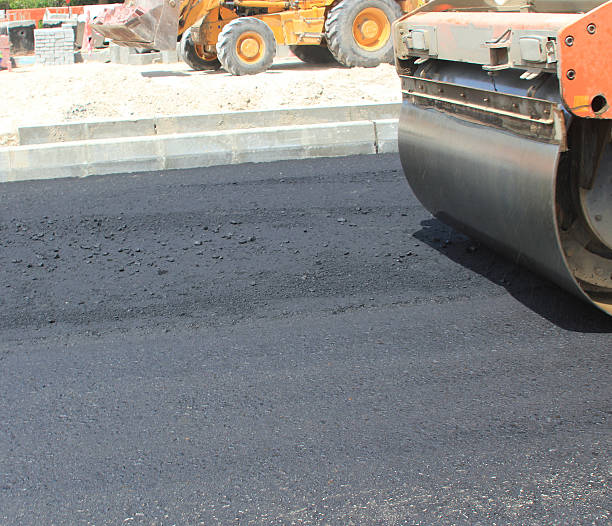 istock Compactor flattening asphalt on a new road 473288502