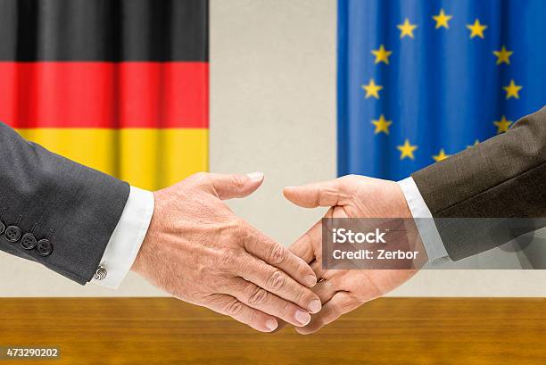 Representatives Of Germany And The Eu Shake Hands Stock Photo - Download Image Now - 2015, Achievement, Adult