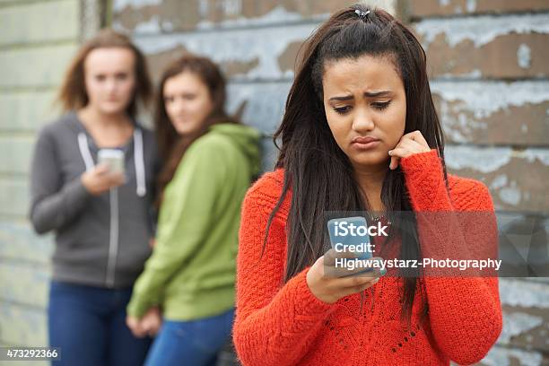 Teenage Girl Being Bullied By Text Message Stock Photo - Download Image Now - Cyberbullying, Bullying, Teenager
