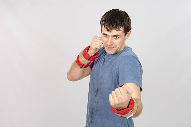 istock Athletes perform punches with the weighting 473292986