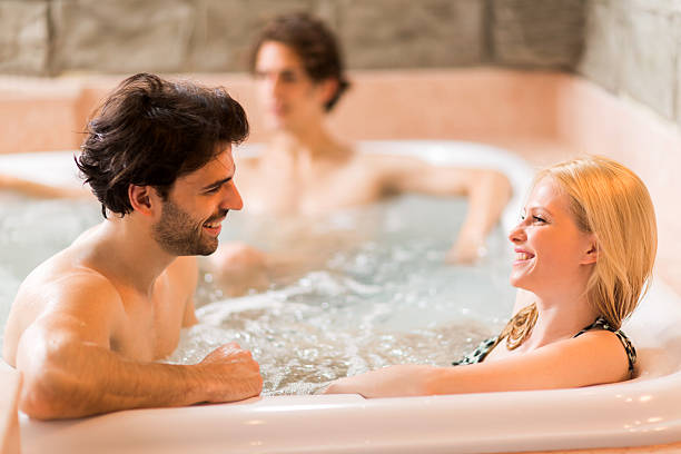istock Young happy couple communicating while being in hot tub. 473294776