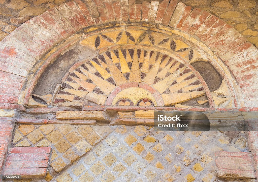 Details in the old town of Ostia, Rome, Italy Details of an ancient roman tomb (Tomb of the Small Arches) in the Necropolis of Ostia old town, Rome, Italy, heritage of early italian history, now travel destination for tourists. 2015 Stock Photo