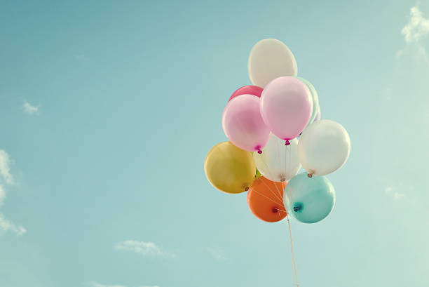istock Bunch of balloons floating in the bright blue sky 473299332