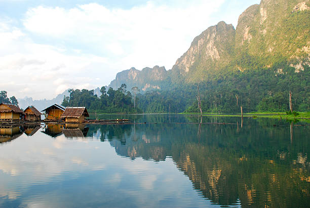 istock Tropical lakeside hut and wooden boat 473300168