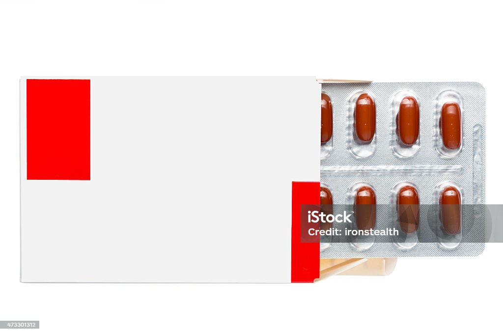 White box with brown in a blister pack White box with brown pills in a blister pack on an isolated background 2015 Stock Photo