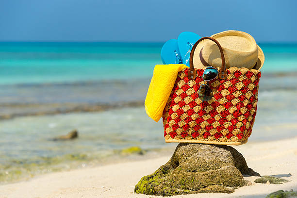 istock Summer beach bag with shell, towel on sandy beach 473301566