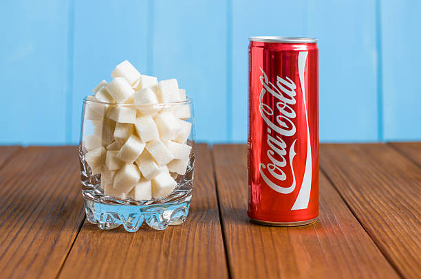 Kiev, Ukraine May 8, 2015. Coca-Cola and glass with sugar. KIEV, UKRAINE - MAY 8, 2015: Can of Coca-cola and a glass of sugar. coke zero photos stock pictures, royalty-free photos & images