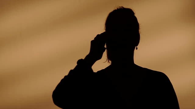Female silhouette calling on the phone