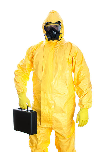 istock Man with briefcase in protective hazmat suit. Isolated on white. 473308494