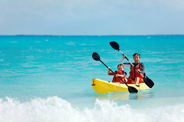 Father and son kayaking stock photo