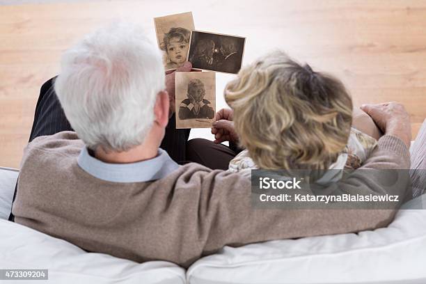 Marriage Looking At Photos Stock Photo - Download Image Now - Photograph, Photography, Looking