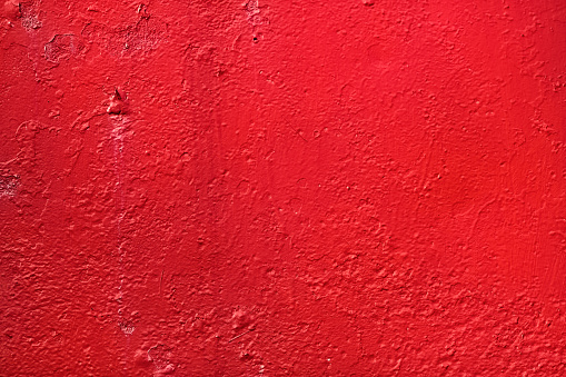 Red background. Bright painted old textured wall.