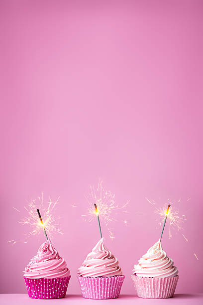 istock Pink cupcakes with sparklers 473311858