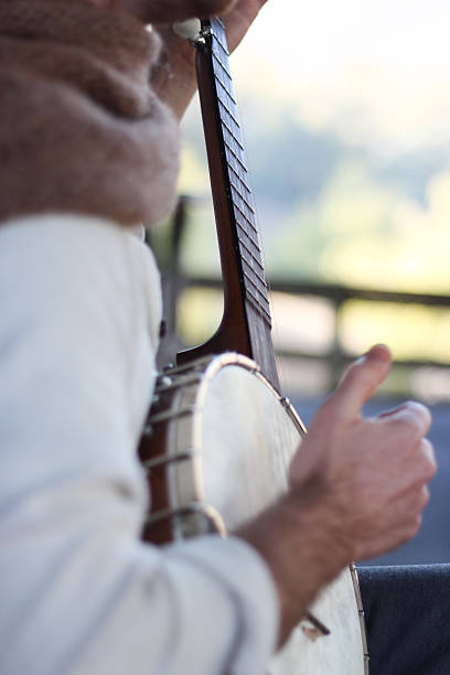 istock Guy picking his banjo with a natural background 473311890
