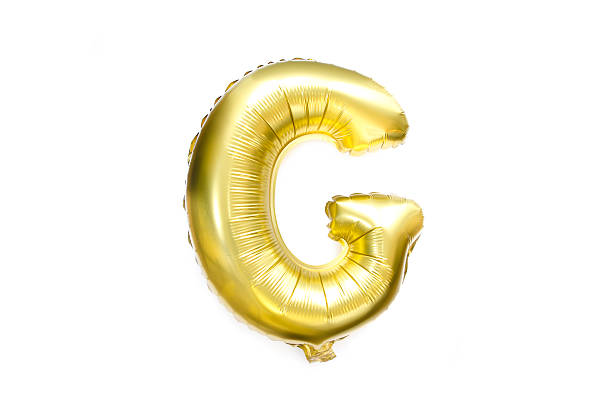 Golden Alphabet Foil Balloon Letter G Photog of Large Golden Alphabet Foil Balloon Capital Letter G isolated on white background gold g stock pictures, royalty-free photos & images