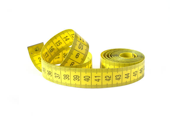 istock Yellow measuring tape isolated closeup 473312414