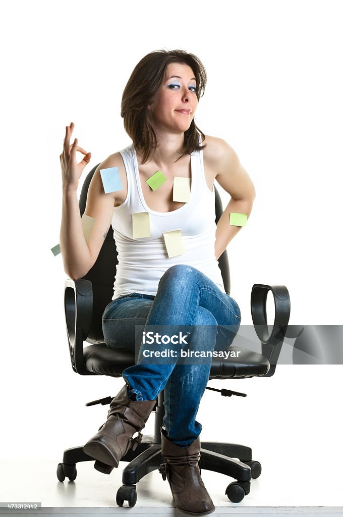 Beautiful young woman at work Beautiful young woman at work with many post-its on her, getting bored. 2015 Stock Photo