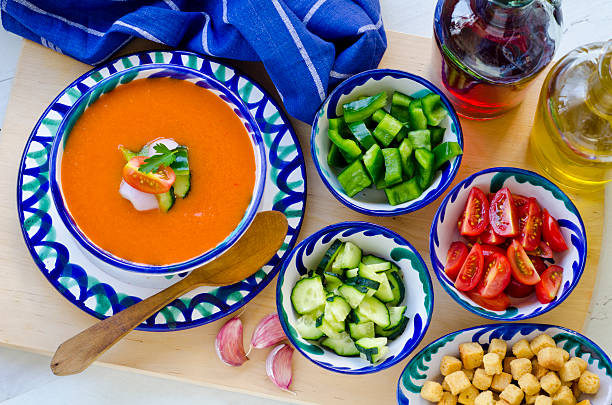 Spanish gazpacho and its ingredients in blue bowls stock photo