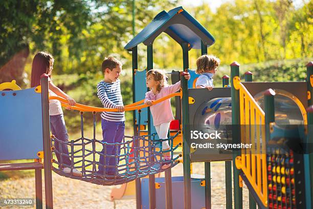 Children Playing In The Park At Playground And Communicating Stock Photo - Download Image Now
