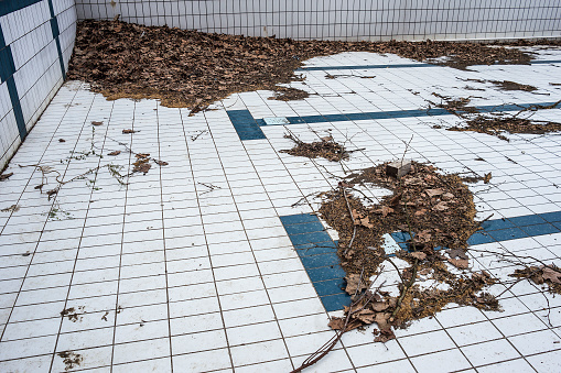 Dirty corner in abandoned swimming pool.