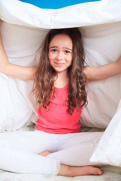 istock young girl lying on the bed under the covers 473317338
