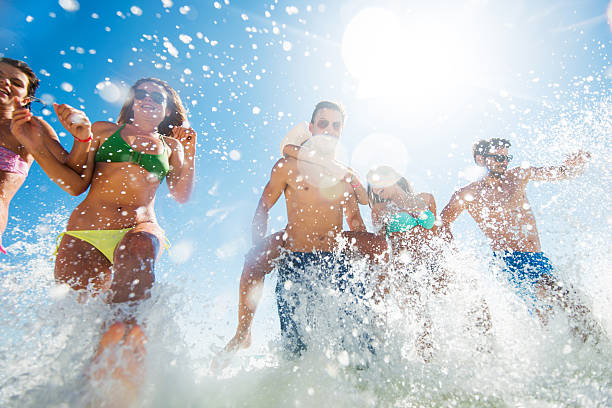 istock Below view of young people having fun in the sea. 473319036