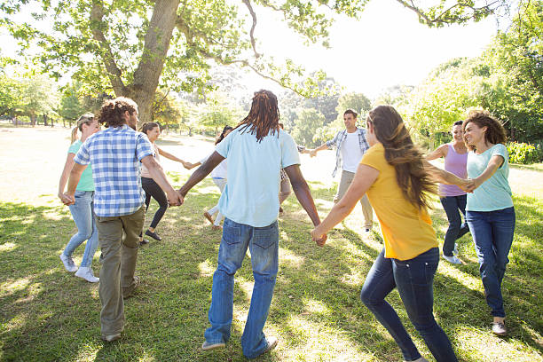 istock Happy friends in the park holding hands 473321088