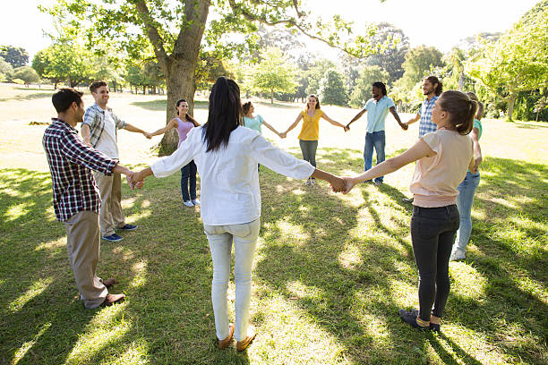 istock Happy friends in the park holding hands 473321102