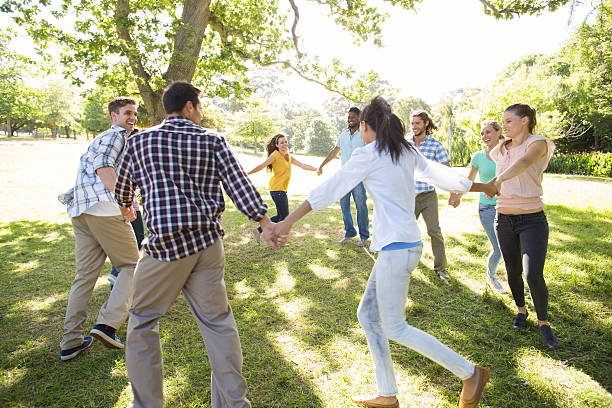 istock Happy friends in the park holding hands 473321116