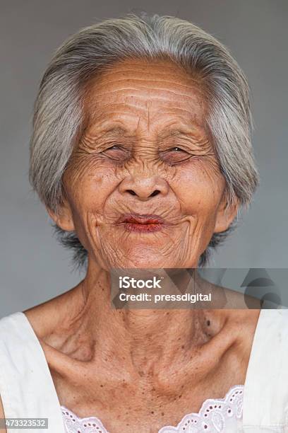 Elderly Asian Woman Smiling With Her Eyes Closed Stock Photo - Download Image Now - 2015, Adult, Adults Only