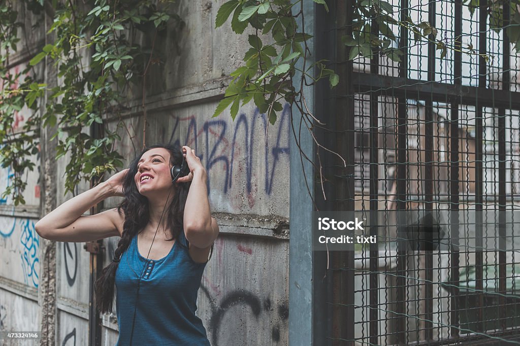 Detail of a girl posing in the city streets Beautiful girl with long hair posing in the city streetsDetail of a young beautiful woman posing in the city streets 2015 Stock Photo