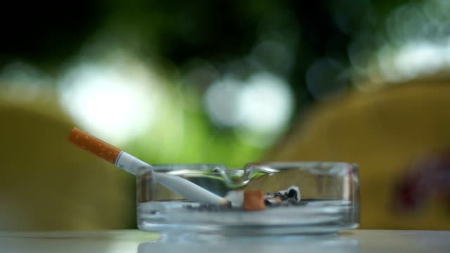 Smoking Cigarette In Ash Tray