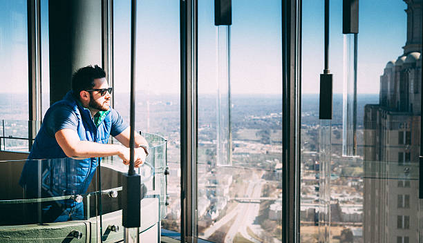 istock Man looking out of a window 473326088