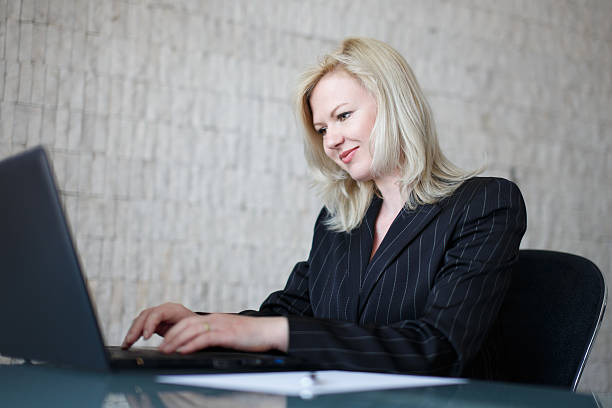 istock Confident businesswoman typing on laptop 473326198
