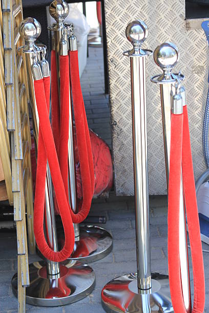 istock Crowd control barriers with red velvet rope 473329224