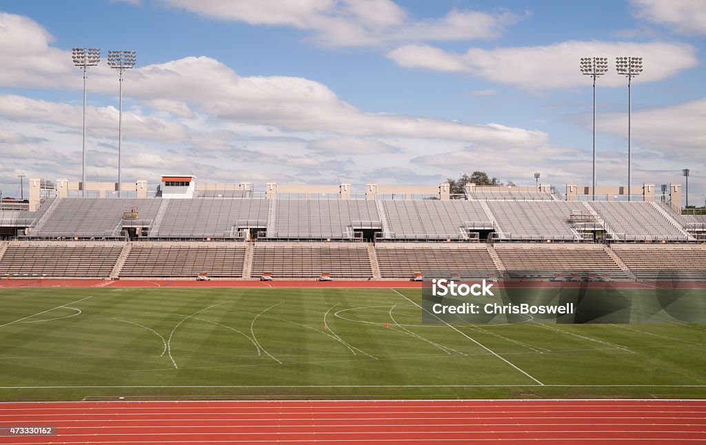 College Level Track Stadium Puffy Clouds Blue Sky Empty track stadium on a beautiful sunny day Stadium Stock Photo