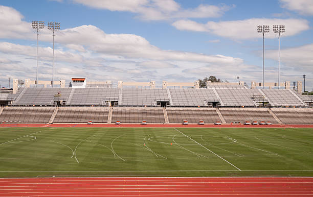 College Level Track Stadium Puffy Clouds Blue Sky Empty track stadium on a beautiful sunny day school bleachers stock pictures, royalty-free photos & images