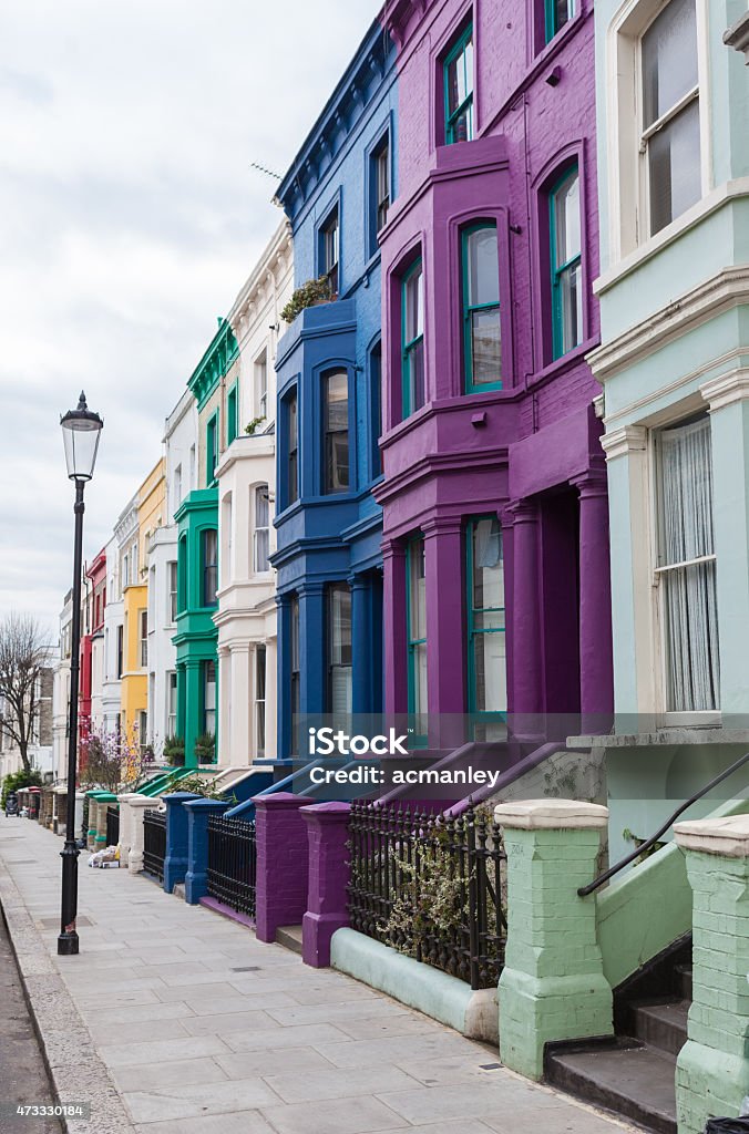 Victorian terraced houses colourfully painted Coloured properties on Lancaster Road in Notting Hill neighbourhood, north west London. Notting Hill Stock Photo