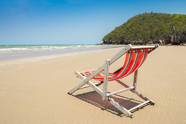 istock beach chair on the beach and mountain scenic. 473334742