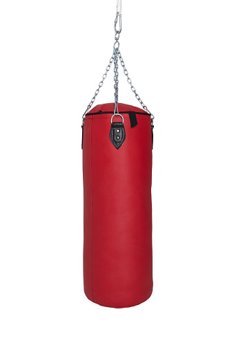 a red punching sandbag for boxing isolated on white background.