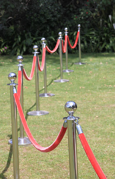 istock Crowd control barriers with red velvet rope 473341246