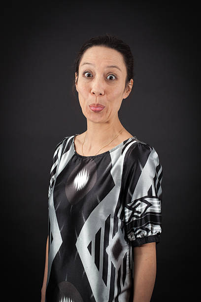 A light-skinned girl in glasses, a red skirt, a green shirt and yellow boots stands relaxed against a white background. With space for text 3d-rendering.
