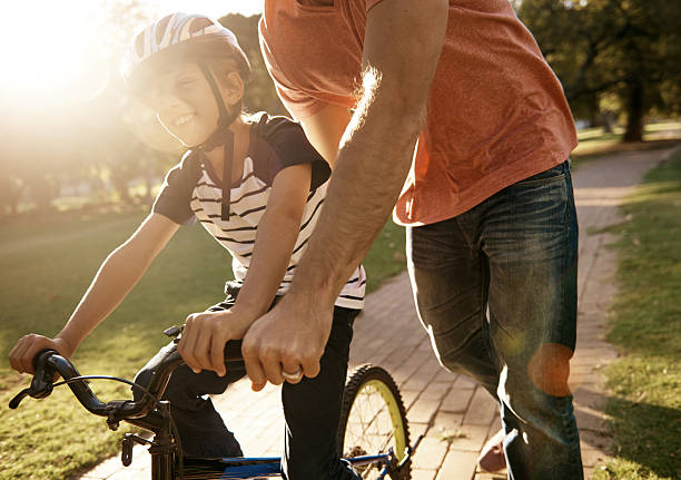 istock Testing out his new wheels at the park with dad 473347922