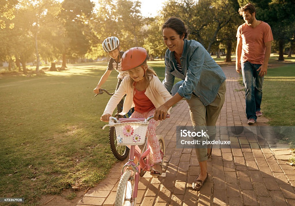 The love coming to the park Shot of a woman teaching her daughter how to ride a bicycle at the parkhttp://195.154.178.81/DATA/i_collage/pu/shoots/804584.jpg Cycling Stock Photo