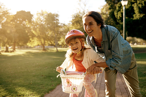 Shot of a woman teaching her daughter how to ride a bicycle at the parkhttp://195.154.178.81/DATA/i_collage/pu/shoots/804584.jpg