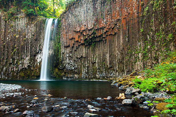 istock Water falls over cliff of columnar basalt 473355570
