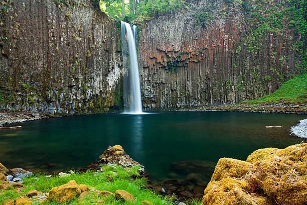 Water falls over cliff of columnar basalt stock photo