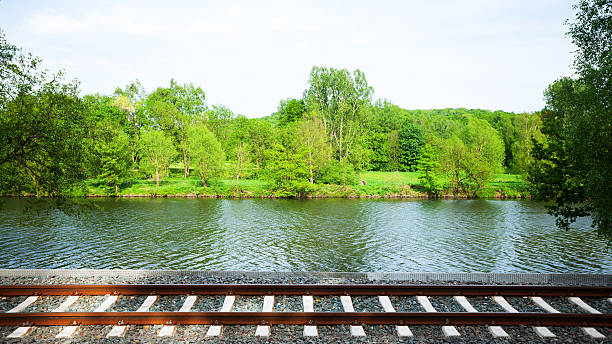 Railway tracks and river Ruhr in south of Essen. Tracks of line S6 between Essen and Cologne. Spring shot.